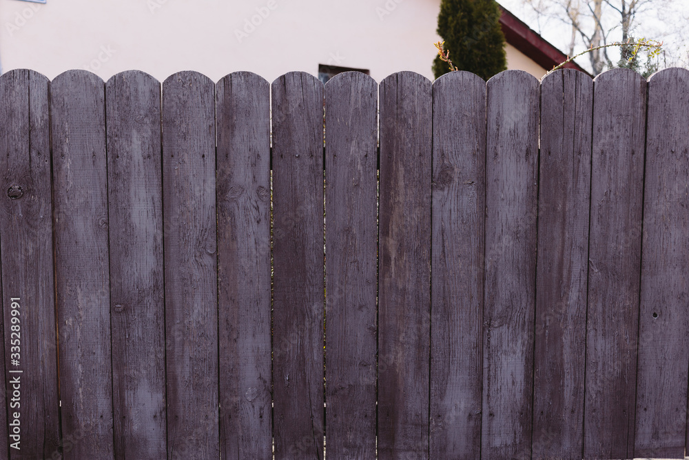 Fototapeta premium Closeup dark violet rough wood fence. Beautiful lilac not flat background. 