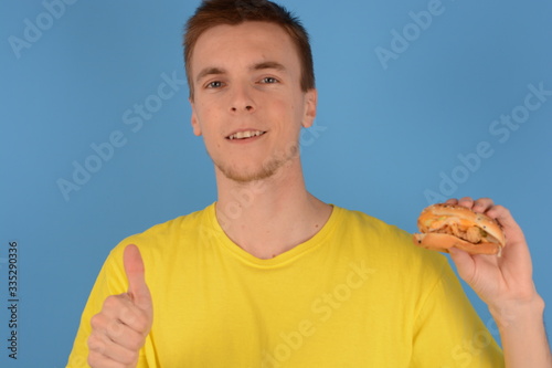 man smiling thumbs up hamburger fast food