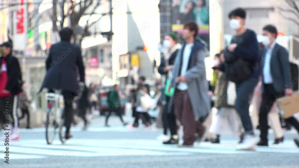 TOKYO, JAPAN -FEB 2020 : Crowd of people at Shibuya Scramble Crossing in busy weekend. Many pedestrians (Japanese people and tourist) at the street. Focus in front. Modern city lifestyle concept shot. TOKYO, JAPAN -FEB 2020 : Crowd of people at Shibuya Scramble Crossing in busy weekend. Many pedestrians (Japanese people and tourist) at the street. Focus in front. Modern city lifestyle concept shot.