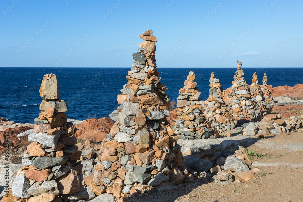 Stones Piled on Each Other near Coastline: Rocks and Cliffs near Sea