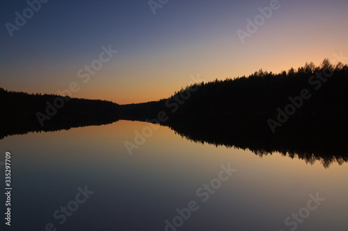 Fototapeta Naklejka Na Ścianę i Meble -  Sunset on the lake in the woods