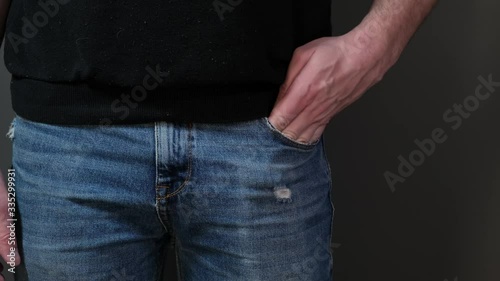 Hand pull out mobile phone of jeans pocket