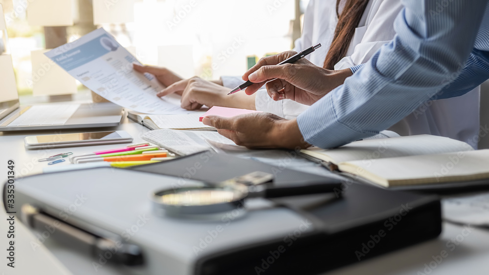 Young unemployed is searching for a job in the newspaper and laptop. Interview the job and hiring concept.