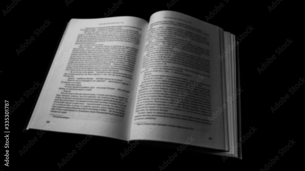Book opened blurred black and white photo. dark background Book opened blurred black and white photo. dark background