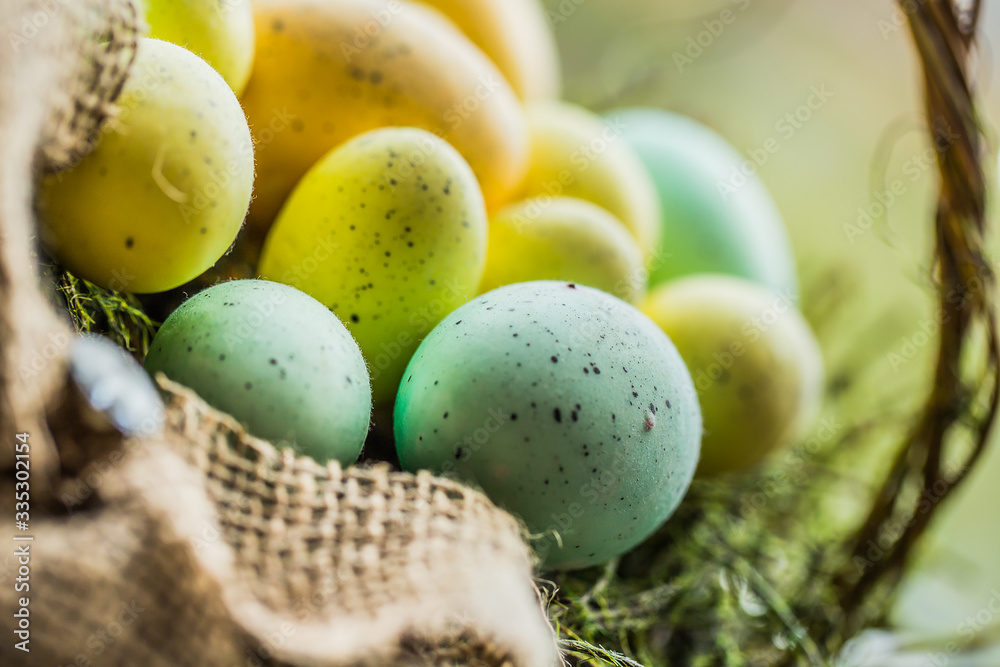 Easter eggs in basket on wooden background