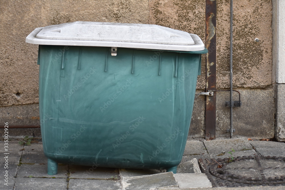 Green plastic dumpster at old abandoned Tempelhofer Feld in Tempelhof Berlin Germany Green plastic dumpster at old abandoned Tempelhofer Feld in Tempelhof Berlin Germany