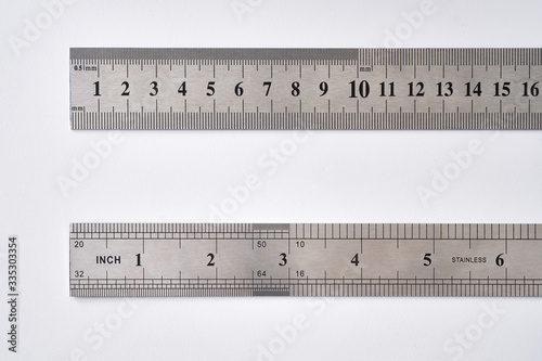 Stainless metal rulers on white background