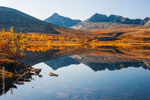 Mountains reflecting in lake at autumn, Norway, 