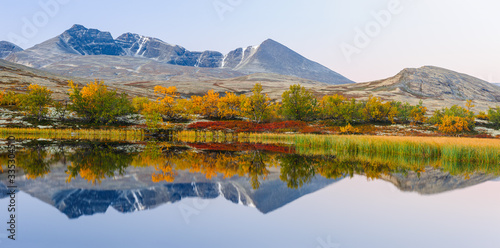 Mountain reflection in lake at autumn  Norway  