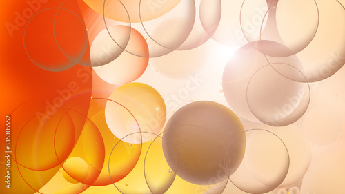  bright oily drops in water with colorful background, close-up
