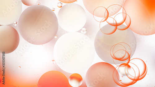 bright oily drops in water with colorful background, close-up 