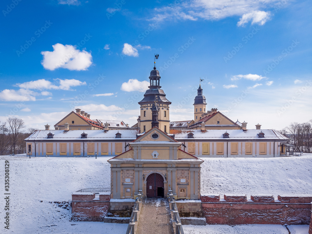 The winter view of the main entrance of Nesvizh Castle in Belarus. Drone aerial photo