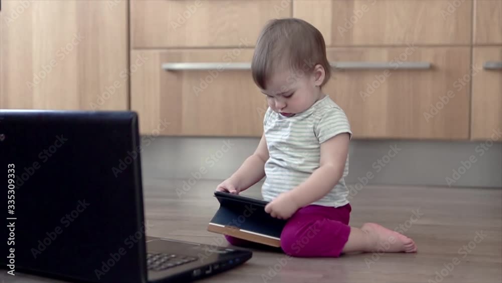 small child plays on computer. The child Prodigy learns the techniques of business Planning, home work, quarantine, self-isolation, protection from coronavirus, virus, home education, distance work. small child plays on computer. The child Prodigy learns the techniques of business Planning, home work, quarantine, self-isolation, protection from coronavirus, virus, home education, distance work.