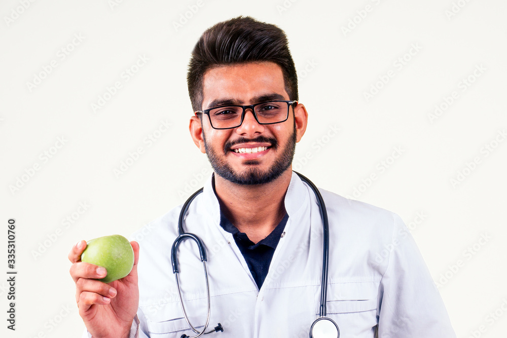 indian male in medical uniform eating apples white isolate studio background indian male in medical uniform eating apples white isolate studio background