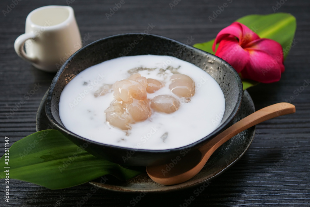 Sticky rice boiled in syrup with longan and coconut milk dressing. Thai dessert Sticky rice boiled in syrup with longan and coconut milk dressing. Thai dessert