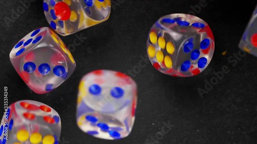 Falling dices on black background. Dice dropping and bouncing in slow motion. Сlose-up. photo