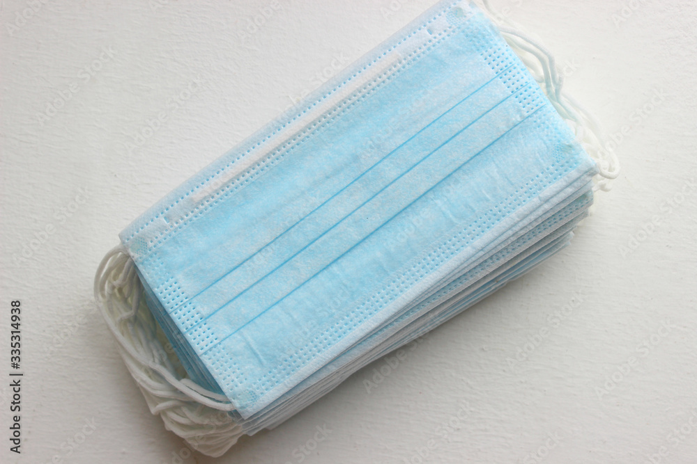 Disposable medical masks on a white background. Protection from infectious diseases. Close up.surgical mask on white background.Surgical protective mask. Concept of coronavirus quarantine.