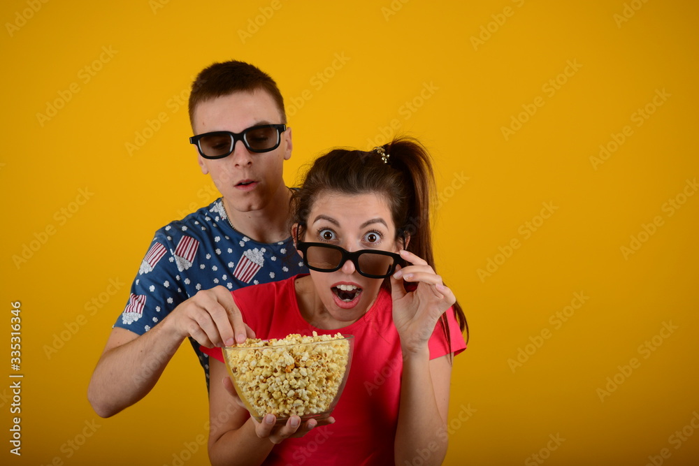 surprised young couple in 3D glasses watching a movie surprised young couple in 3D glasses watching a movie