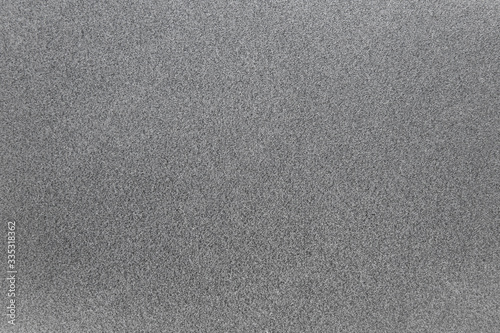 The texture of the metal surface is gray, top view. Neutral background.