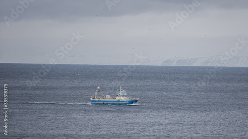 A lone fishing trawler somewhere south of Iceland in the Atlantic Ocean.