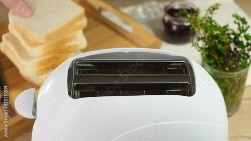 White toaster prepares bread for breakfast. Close up.