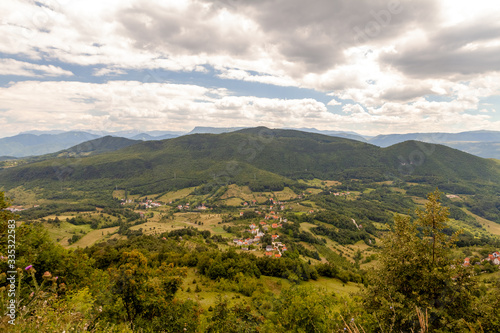 landscape of the village against the background of mountains with clouds