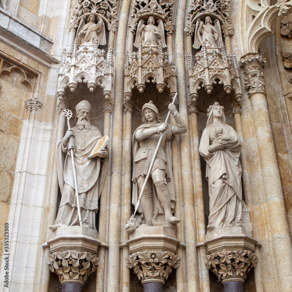 Sculptures of people on the ancient facade of the Church, Europe