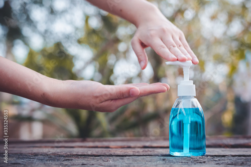 Alcohol hand sanitizer to prevent the outbreak of coronavirus.Women are using alcohol gel to wash hands to prevent the spread of the covid-19 virus.