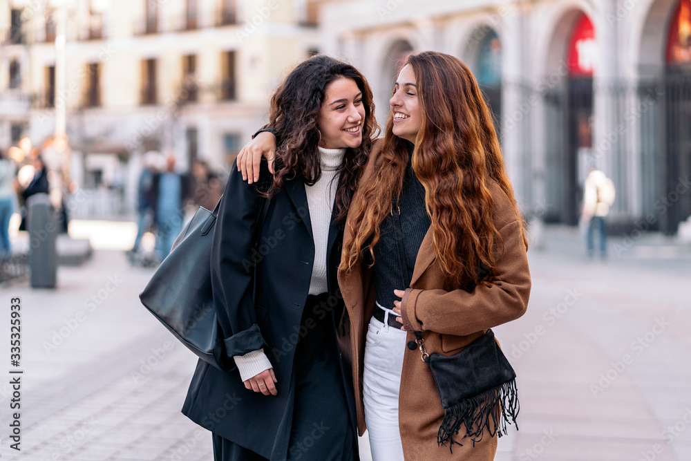 Fototapeta premium Two caucasian women walking together