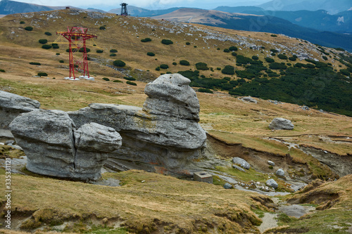 Huge sphinx-like stone in the Bucegi Natural Park in Romania. Megaliths on top of a mountain range, tourist attraction.