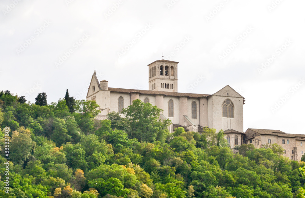 The st. Francis church of Assisi seen from the walking path that lead to this little medieval town on the St. Francis way pilgrimage, a full immersion in nature, culture and history