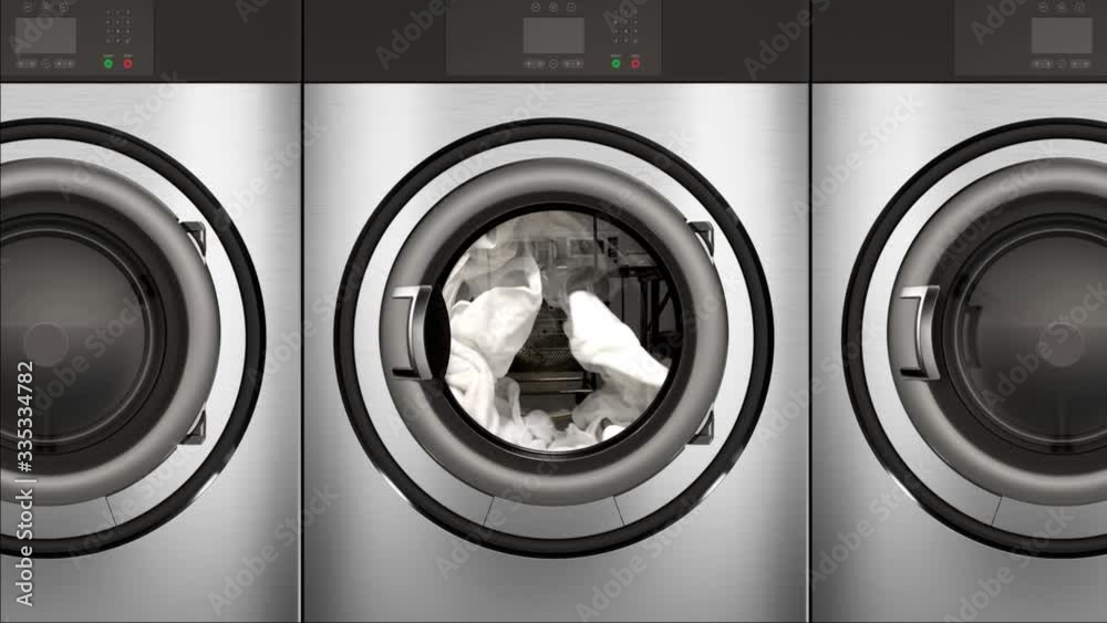 4K seamless slow motion animation of a commercial dryer full of bright white clean towels.