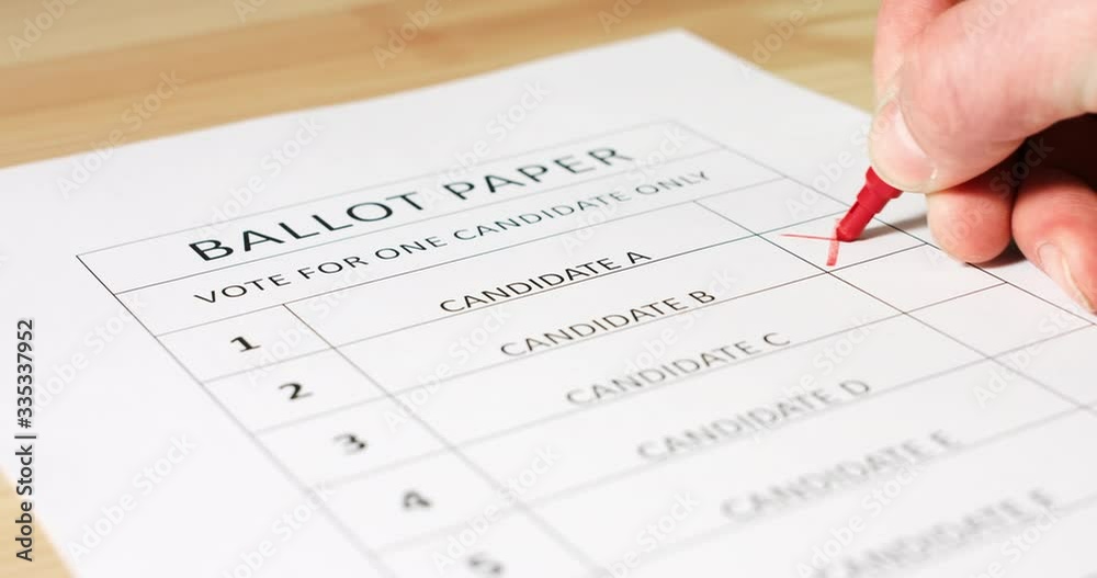 Voter's hand selecting and marking his president candidate on ballot paper for elections. Voter's hand selecting and marking his president candidate on ballot paper for elections.