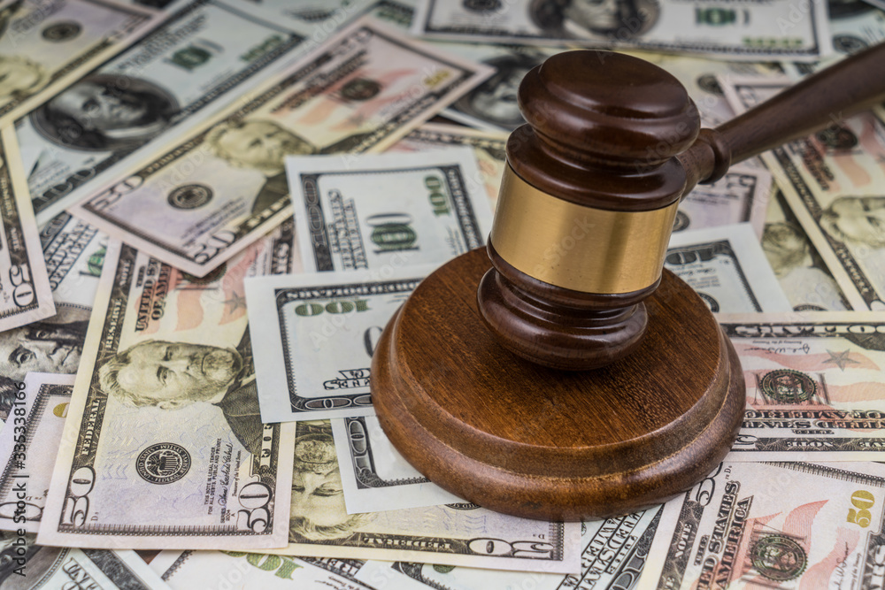 Gavel judge on the background of money dollars banknotes. Business concept, tax, pledge. Court law Gavel judge on the background of money dollars banknotes. Business concept, tax, pledge. Court law
