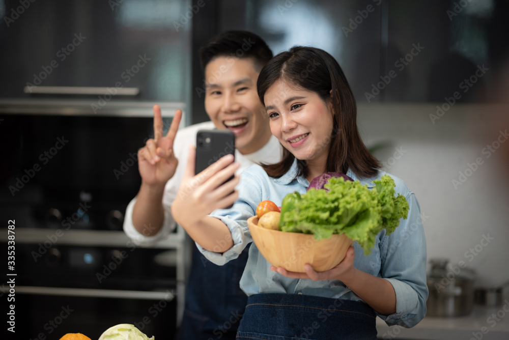 work from home, couple live streaming with cooking and kitchen concept work from home, couple live streaming with cooking and kitchen concept