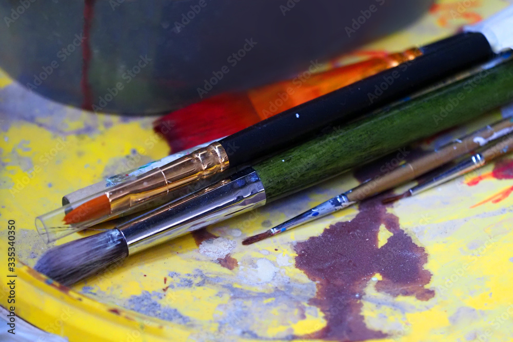 Obraz premium Creation. Dirty brushes and paint cans, stains of paint, art background