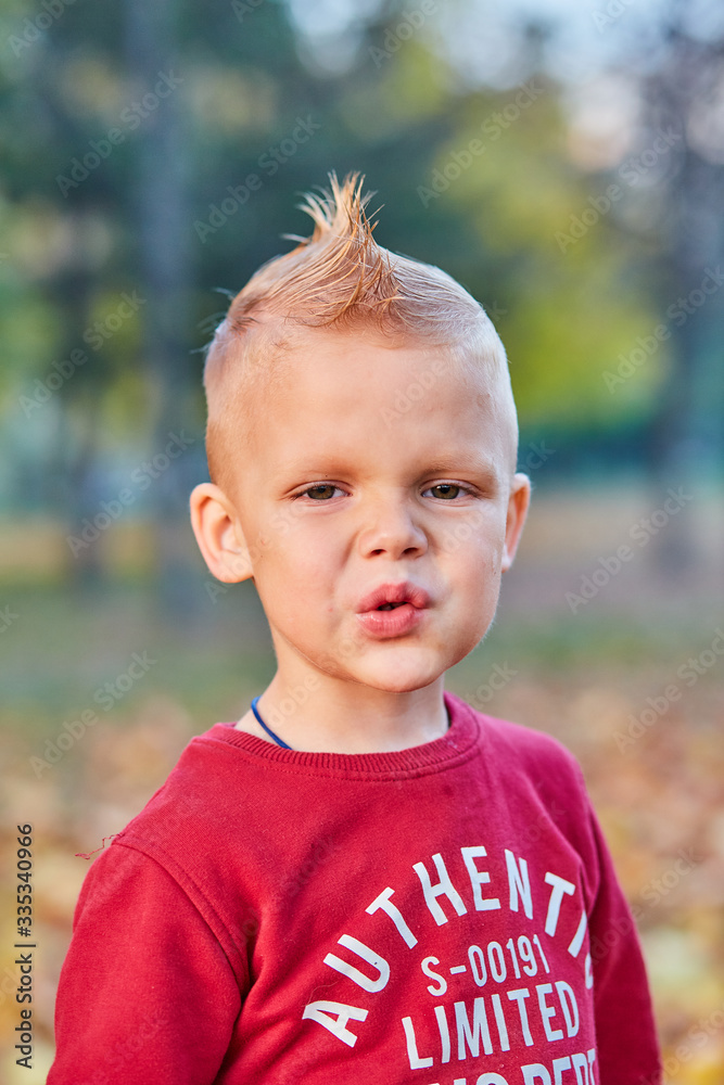 Beautiful little boy shows macho grimace Beautiful little boy shows macho grimace