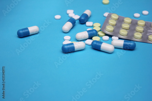 a lot of pills and pills on it on a blue background.
