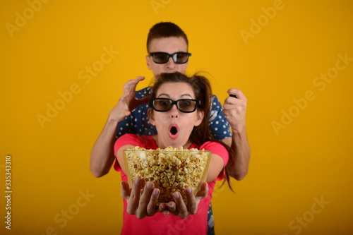 woman and man in 3d glasses with popcorn rest movie advertisement