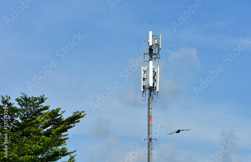 Wireless Communication Antenna With bright sky.Telecommunication tower with antennas.High pole for signal transmission. There are both wireless phone systems and microwave systems.