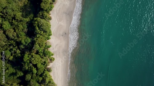 Aerial/drone View of Tropical espadilla beach and Coastline near the Manuel Antonio national park with its green rain forest on a sunny day, Costa Rica photo
