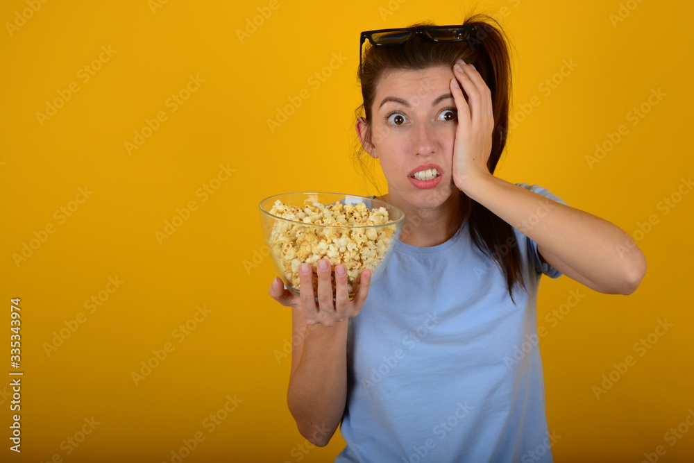 woman eating popcorn on an isolated background woman eating popcorn on an isolated background