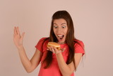 woman in a t-shirt with a burger in her hand advertising fast food place free