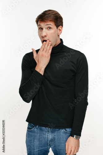 surprised young man on white studio background