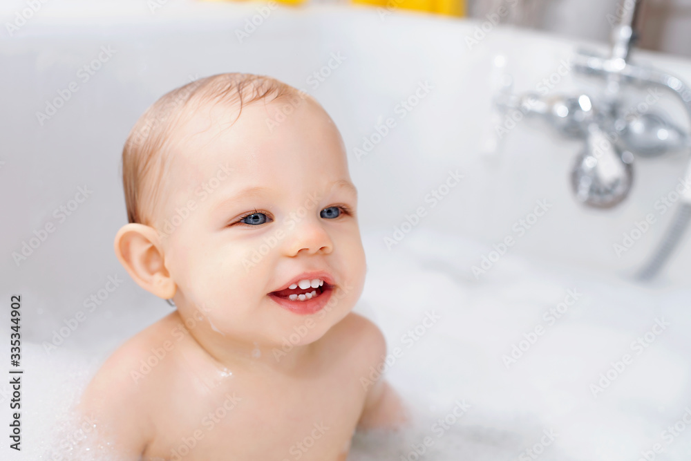 Portrait of happy baby boy sitting in bathtub Portrait of happy baby boy sitting in bathtub