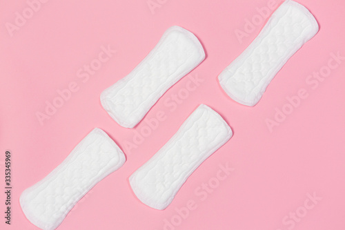 White feminine pads on a pink background