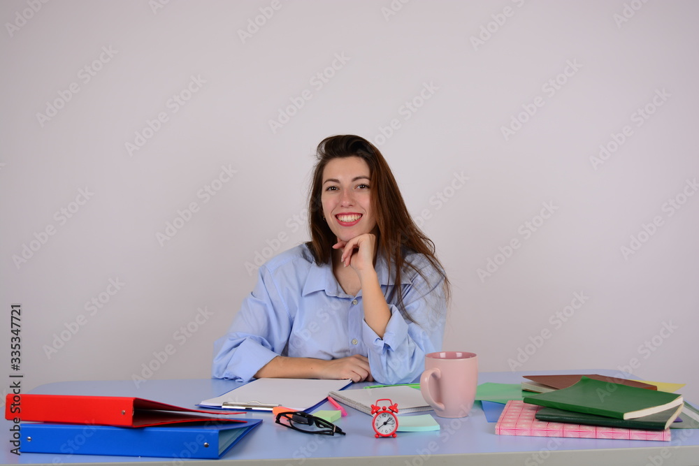 woman in shirt sits at table in office business work documents woman in shirt sits at table in office business work documents