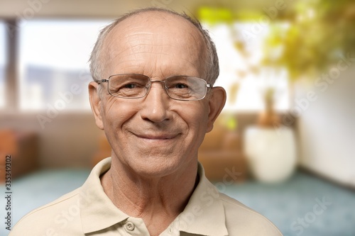 Old senior man standing on blur background