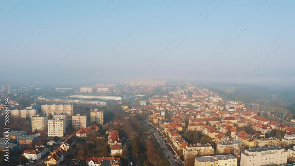 Aerial drone flight Over Prague city center district six at sunrise, smog and morning fog visible Aerial drone flight Over Prague city center district six at sunrise, smog and morning fog visible