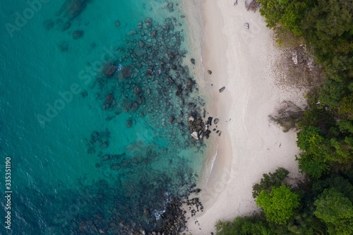 Fototapeta Naklejka Na Ścianę i Meble -  Aerial drone view of tropical empty beach with turquoise sea water and rocks